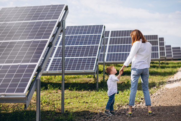 Mother and child walking around solar panels